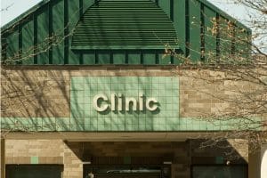 A building that says clinic on the front of it.