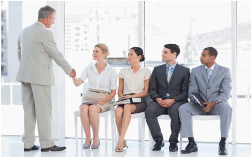 A group of people sitting in front of each other.