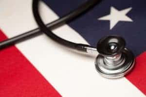 A stethoscope on top of an american flag.