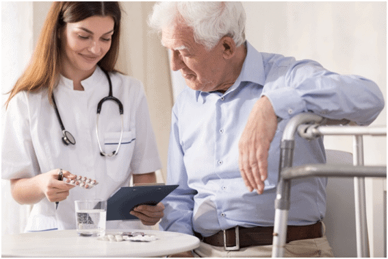 A nurse and an older man in blue shirts.