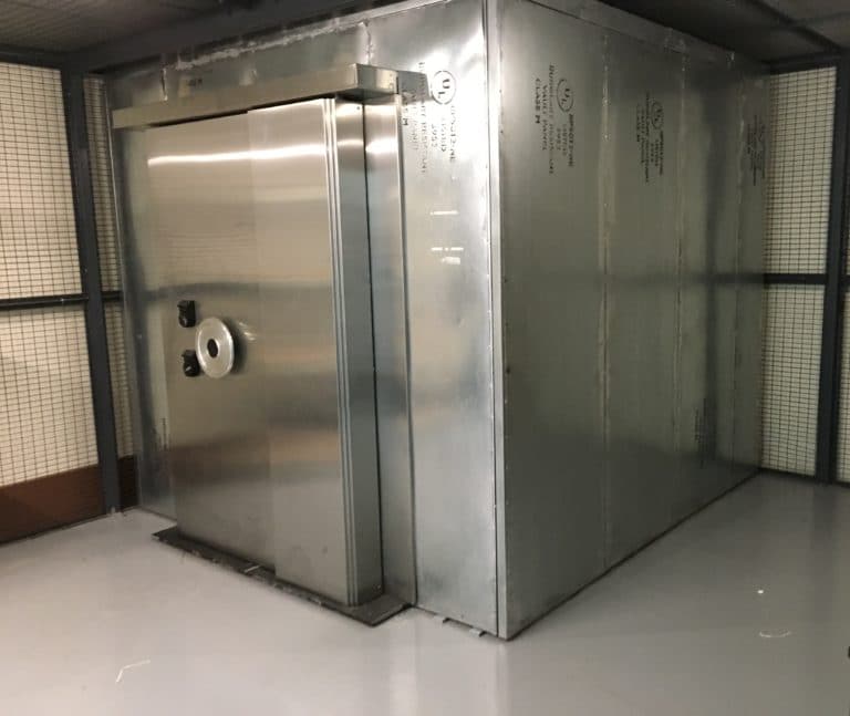 A large metal door in the middle of a room.