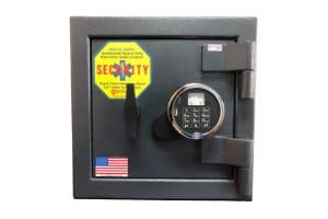 A black safe with a yellow sign and a cell phone.