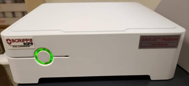 A white box with green button on it