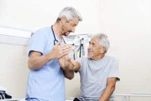 Two men in scrubs are talking to each other.