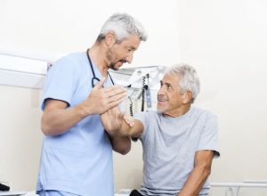 Two men in scrubs are talking to each other.